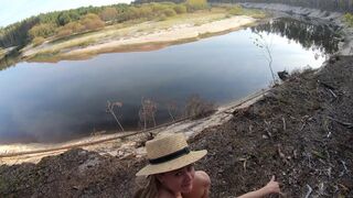 Girl masturbates on the bank of a beautiful river