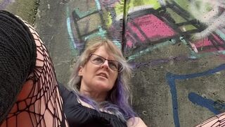 MILF fucks herself by busy mall